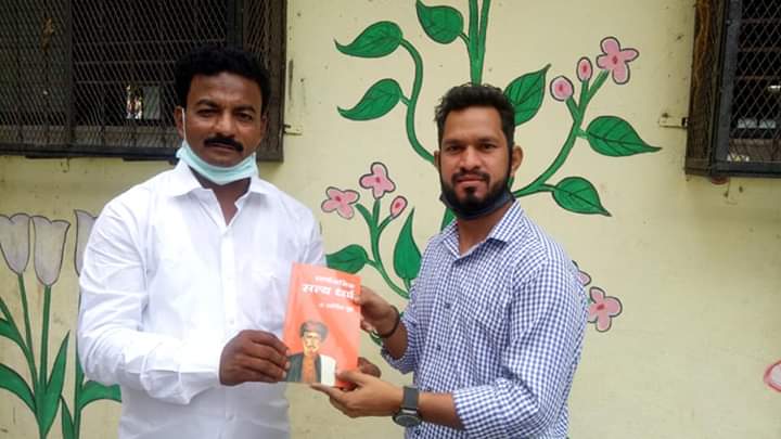 Presenting book to Social Worker Kutubuddin Hobale